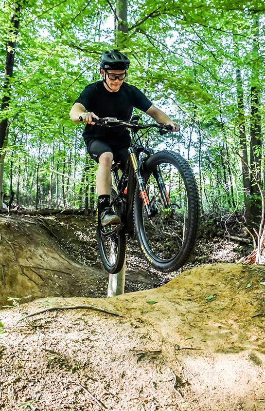 boy riding bike in the woods